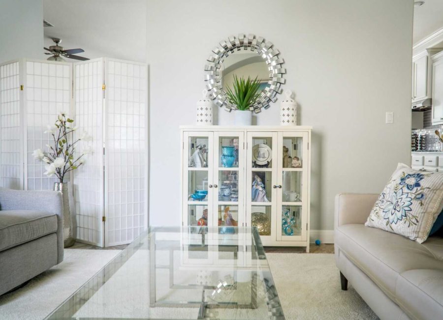 Bright living room with modern decor, featuring a glass table, plush sofas, and decorative elements in Austin, TX.