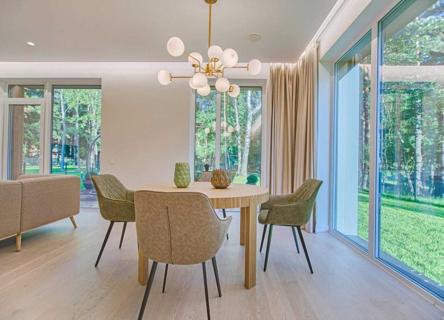 Elegant dining room featuring modern furniture and large windows for natural light.